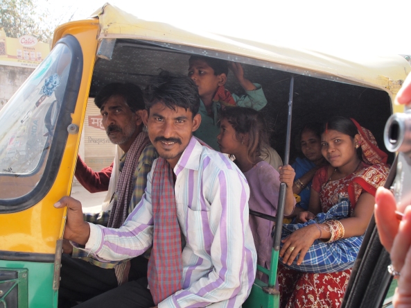 whole families pack into auto-rickshaws