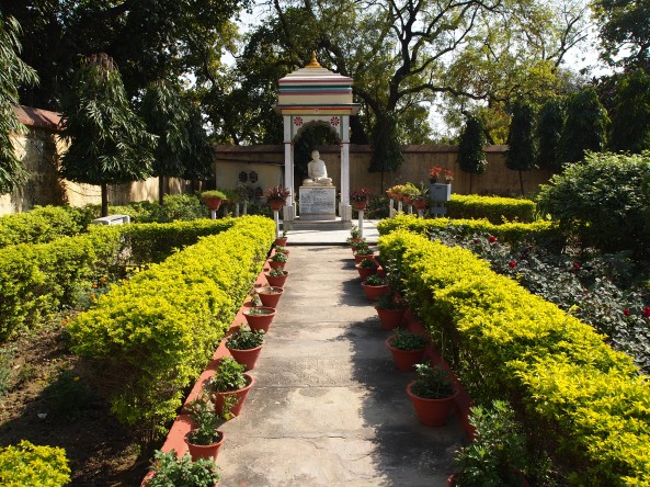 the buddha on the grounds of the jain temple