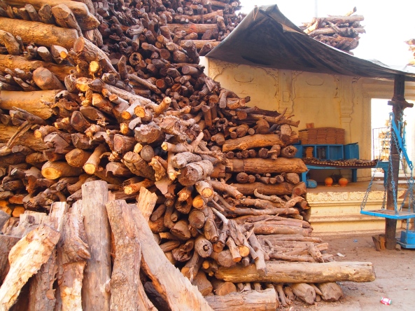 huge stacks of wood at the burning ghat