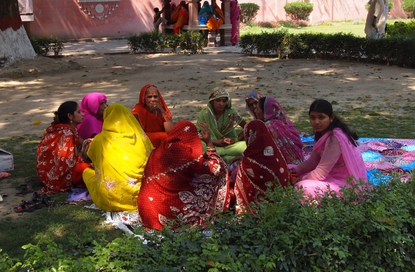 colorfully-dressed women have a picnic